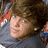 Pixelated image of a person with brown hair and blue eyes wearing a gray shirt, next to orange text on black background reading Ryan Sheckler Best sk8r Ever!!!!