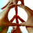 Brown and white peace symbol with brown border on light blue background, static image.