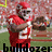 A football player in a red uniform with white stripes and number 21 holds a football, with text overlays reading 'bulldozer biathlete' and 'joker' across the image.