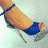 A static image showing a blue high-heeled shoe, diamond ring, dollar bills, and red lip gloss with the text 'Girls Needs' partially visible.