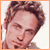 A 50x50 pixel animated buddy icon featuring a side-profile portrait of a person with light brown hair on the left and an orange grid background with text on the right, displayed as a contact sheet with two frames.