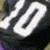 Black fabric with large white numerals '10' displayed on a sports jersey, visible in four