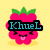 Pixelated pink fruit with green leaves, wearing black sunglasses with blue text, smiling with tongue out on yellow background.