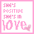 pink and white pixelated text displaying "SHE'S POSITIVE SHE'S IN LOVE" with small heart symbols, some showing animation effects