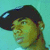 Pixelated profile view of a person with dark hair and greenish skin tones against a light blue background.