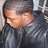 A person in a black leather jacket with short dark hair, shown in three with slight head movement and consistent background
