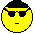 A 4x4 grid of pixelated yellow smiley face icons with black hair, showing various expressions and accessories across 15 sampled frames including sunglasses, braces, and a pencil-and-paper prop.