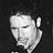 Pixelated grayscale portrait of a person with closed eyes, dark hair, and visible ear against black background.