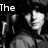 Black-and-white pixelated image of a person with dark hair and layered clothing, partially overlaid by text fragments.