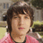 A pixelated image shows a person with brown hair wearing a pink shirt, next to a red background with white text reading '<3 cappie'.
