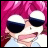 Pixelated anime-style character with pink hair and dark sunglasses against a black background, with text reading 'AnimeIM' and 'c0m' in white.