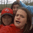 Three people in red hoodies and a blue hat pose together; the rightmost person's mouth opens wider across frames.