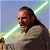 Pixelated static image of a character holding a glowing green lightsaber against a gradient background.