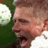 Pixelated close-up of a person's face with visible mouth and partial head, set against green foliage background on a static 48x48 icon frame.