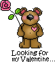 Pixelated brown bear with pink inner ears and cheeks holds a pink rose, has a pink heart on chest, stands against gray background with text below.