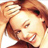 Pixelated close-up of a smiling person with light brown hair and closed eyes, rendered in warm tones on a white background.