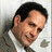 A man in a gray suit and white shirt appears with an Apple logo on the left side of his head, then red text reading 'Monk' overlays his forehead.