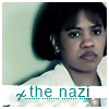A static image of a person with short dark hair wearing a white collared shirt, with text reading 'the nazi' in teal below.