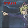 Two side-by-side anime-style frames show a character with spiky blonde hair and purple outfit pointing left, red text changes from STAYN to ALIVE.