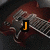 A static image of a red electric guitar with white pickguard and silver hardware, overlaid with sequential text labels in orange and black.