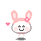 Pixelated bunny avatar with pink ears, white face, and pink flower on head, smiling with closed eyes and pink cheeks, small pink heart to left, gray shadow below.