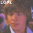 A 4x3 contact sheet of sampled frames from an animated icon featuring a young man with brown hair in a black suit and white shirt, each frame displaying the word "LOVE" in pixelated text at various positions over his face.