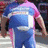 A pixelated image of a person in blue pants and pink shirt with yellow text on an orange background.
