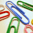 Pixelated image of colorful paper clips on light background with black displaying 'nice' text