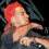 Four pixelated show a red-haired figure in various poses: lying back, drinking from a glass, covering face with hand, and shouting