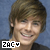 A pixelated image of a person with brown hair and a black shirt, smiling against a blue background, with text overlays reading "ZAC" or "ZACY".