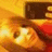 A static pixelated image shows a character with light-colored hair and a dark top against a warm-toned background with orange and yellow hues.