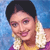 Static pixelated image of a person with short dark hair wearing traditional attire and jewelry against a blue background.
