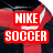 Red and black athletic jersey with white Nike swoosh logo, featuring bold red text reading "NIKE SOCCER" on left side.