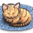 Pixelated orange tabby cat curled into a ball on blue checkered background with closed eyes and pink nose.