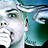 Pixelated static image of a person with light skin, dark hair, and green eyes, wearing a white top against a blue-green background.