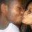 Two figures in close physical proximity with one figure's mouth near the other's face, rendered in low-resolution pixelated style.