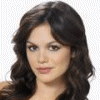 A static image of a person with long dark brown wavy hair, light skin, and neutral expression against a transparent background.