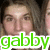 Pixelated close-up of a person with light skin and brown hair, overlaid by bright green lowercase text reading 'gabby' on white background.