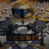 Pixelated static image of a character in armor with blue accents and brown/gold details, likely from Star Wars, set against a blurred background.