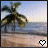 A 48x48 pixel animated contact sheet showing two frames of a tropical beach scene with palm trees, ocean, and sand, featuring a heart icon that changes from white to black between frames.