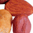 A pixelated image shows a hand holding a nut with a black background displaying red text reading 'om not nutz'.
