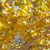 A static pixelated image with a dense pattern of yellow, brown, and green hues forming an indistinct abstract composition.