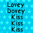 Blue background with light blue stars, repeated text reading 'Lovey', 'Dovey', and 'Kiss' in black font