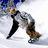 A pixelated figure in a silver jacket and brown pants bends forward on snow, with a blue sky background.