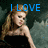 A pixelated image of a woman in a black dress with long hair, showing text changes from 'I LOVE' to 'KELLY!' above her head.