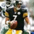 Animated sequence showing a football player in black and yellow uniform holding a brown football, transitioning to close-up of helmet with team logo.