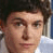 Pixelated portrait of a person with dark curly hair and light skin, next to white text reading LOVE ADAM on black background.
