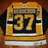A pixelated icon shows a golden calendar frame with the number 37 in bold yellow digits against a black background, set on a brown surface.