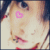 Pixelated close-up of a cartoon-style face with pink heart-shaped eyes, red lips, and light brown hair against a dark background.