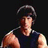 Pixelated image of a person with dark hair wearing a dark sleeveless top against a black background.
